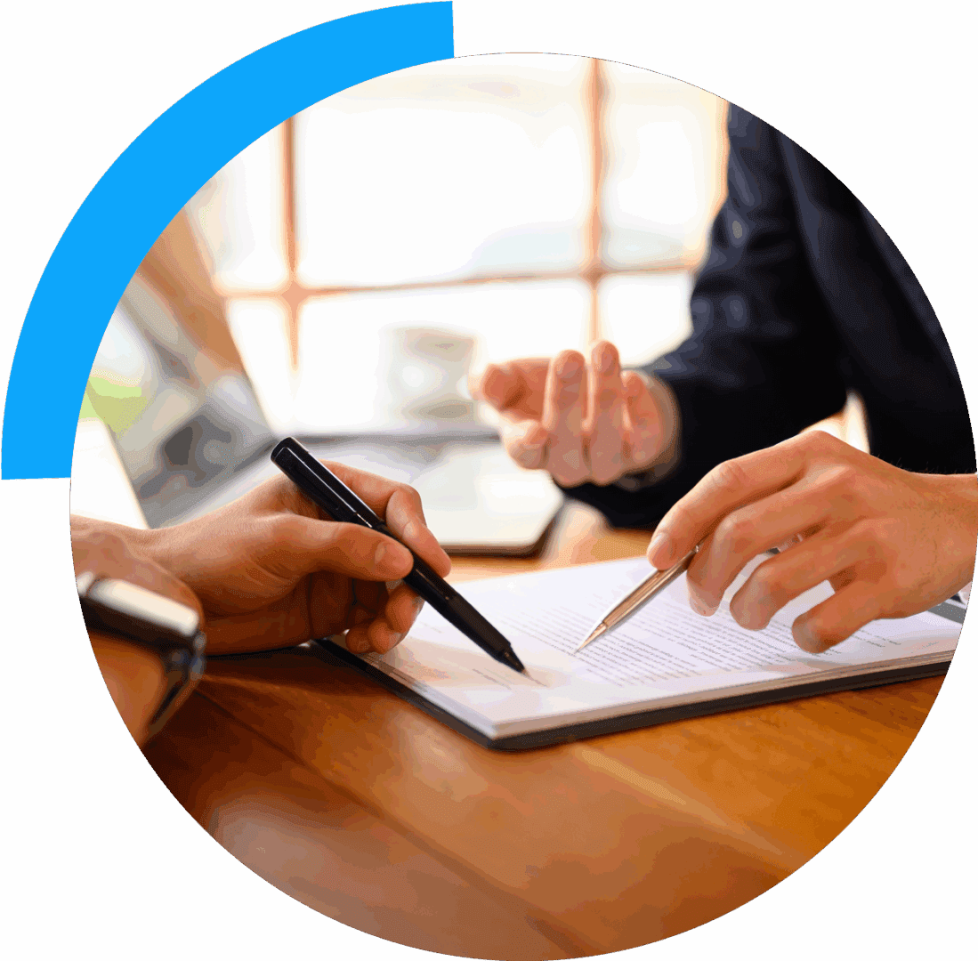 Two people discussing documents at table.
